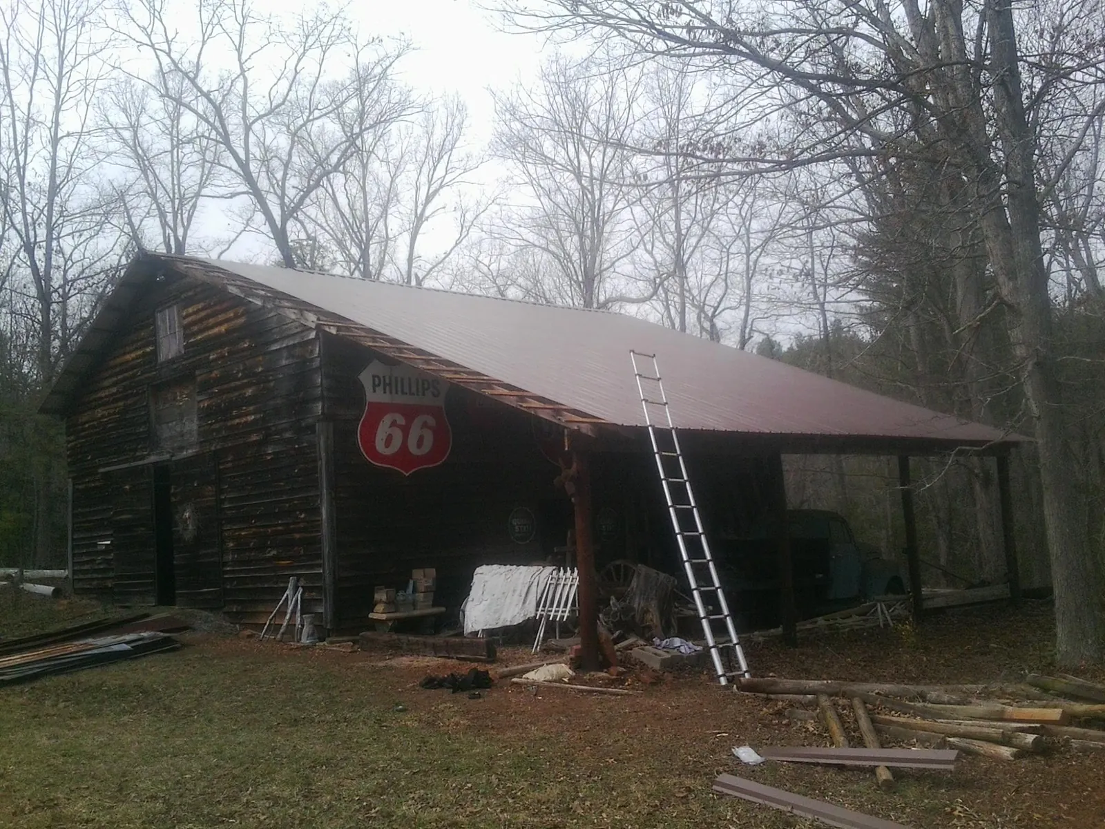 New metal roof on an open sided timber barn with a vintage sign in New Meadows