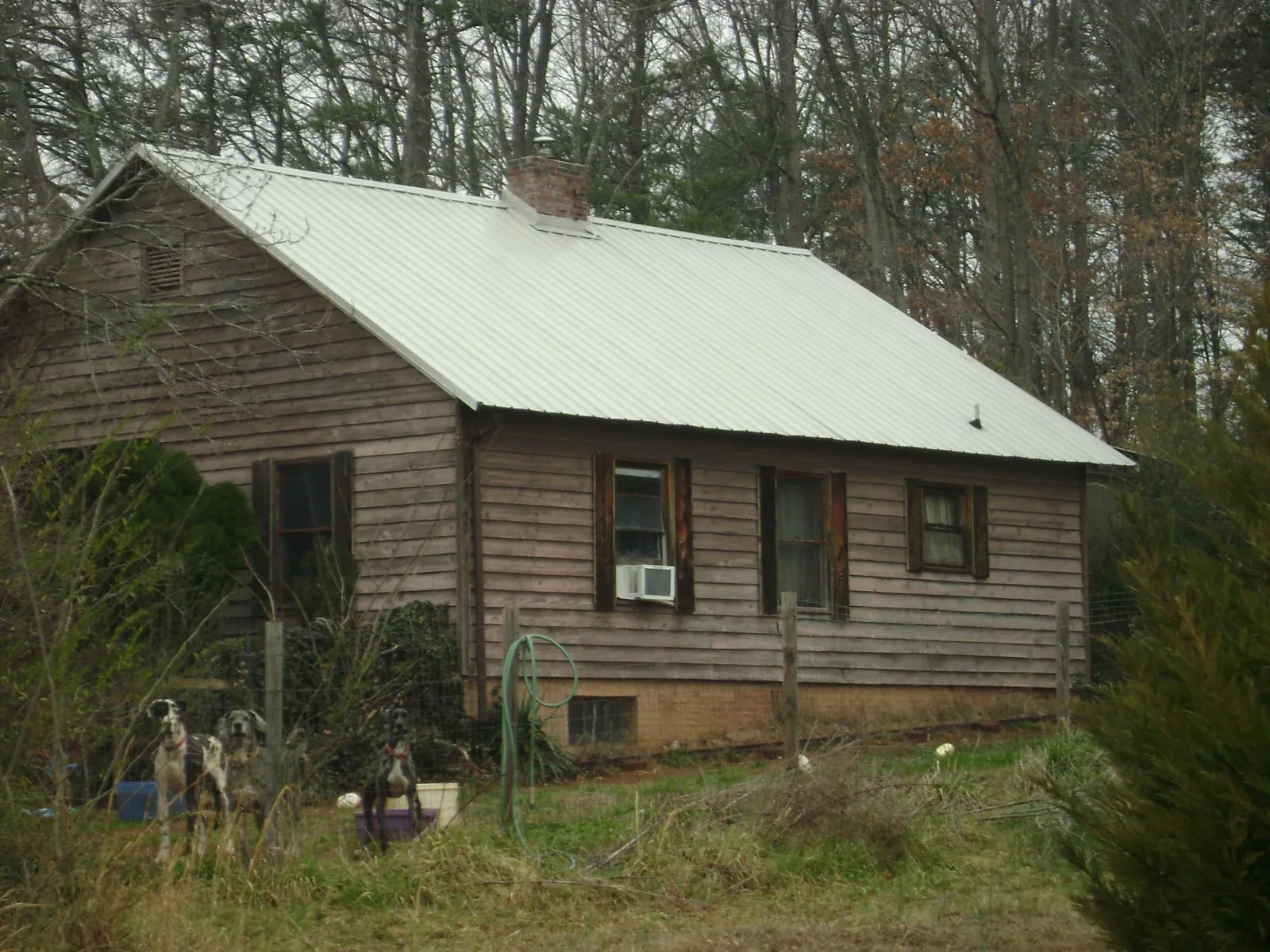 White metal roof on an old wood sided farmhouse, from a Metal Roof Installation job in New Meadows